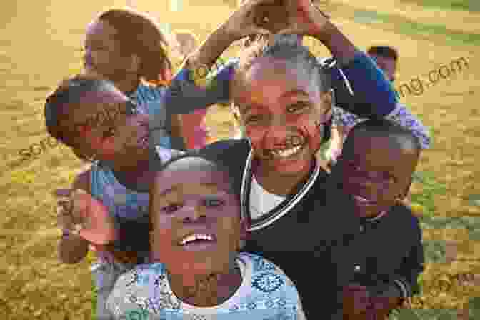 A Man Standing In Front Of A Group Of African Children, Smiling. Born Wild: The Extraordinary Story Of One Man S Passion For Africa