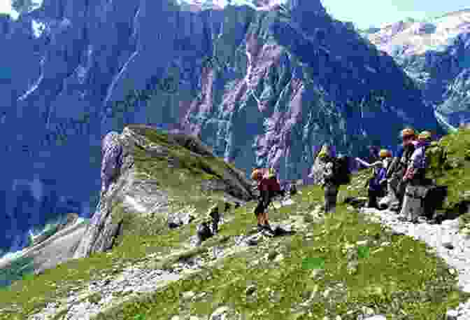 Hikers Ascending A Mountain Trail In The Julian Alps, Surrounded By Lush Greenery And Stunning Mountain Views The Julian Alps Of Slovenia: Mountain Walks And Short Treks (Cicerone Walking Guide)