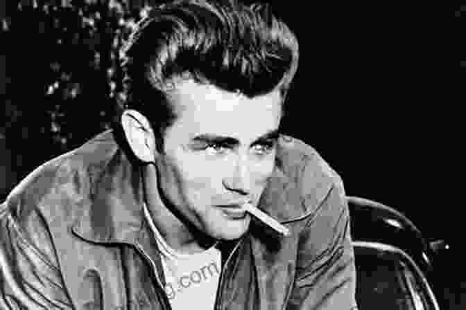 James Dean Posing With A Cigarette In His Mouth, Looking Intense And Introspective James Dean: The Biography Val Holley